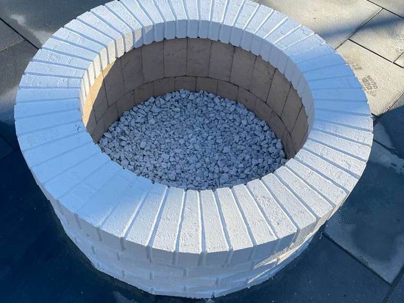 Round stone fire pit with cut cap