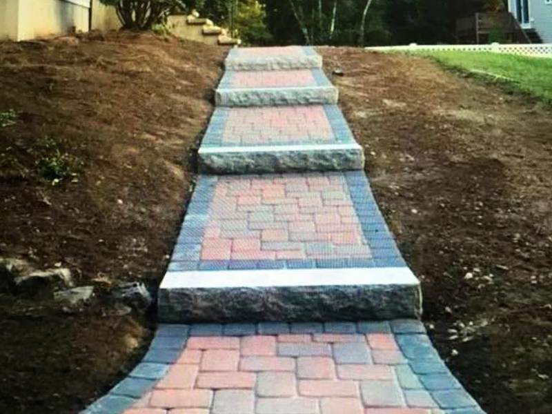 Paver path with contrasting banding through a garden