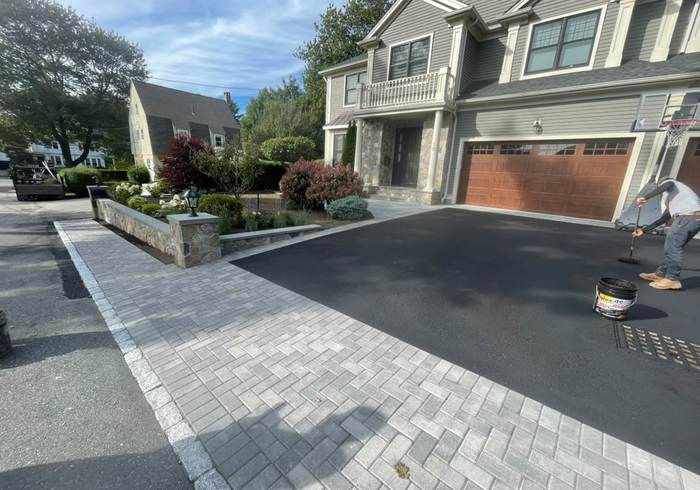 Asphalt driveway with a paver apron and cobblestone border